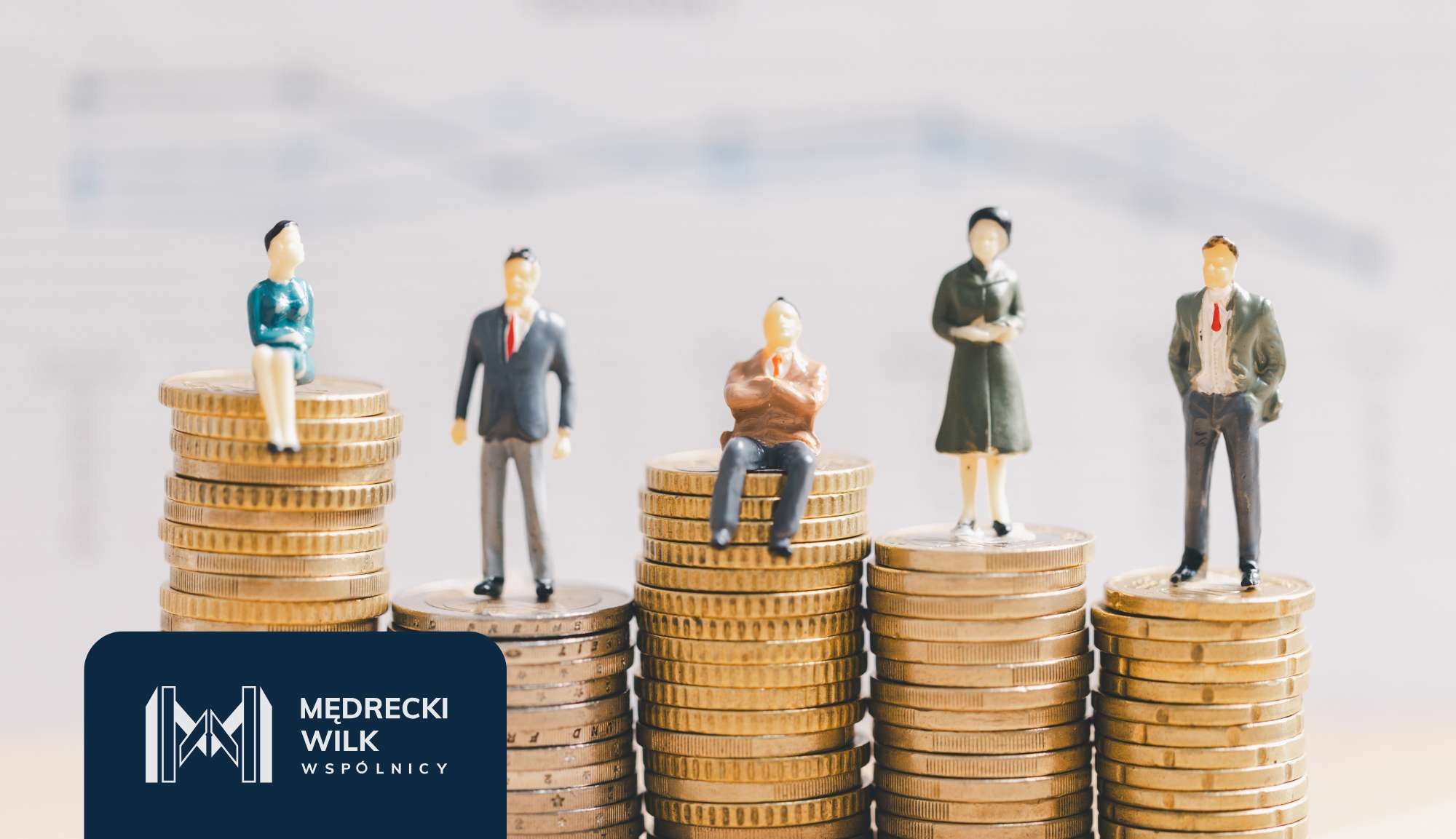 Miniature businesspeople standing on stacks of coins, illustrating financial growth and teamwork.