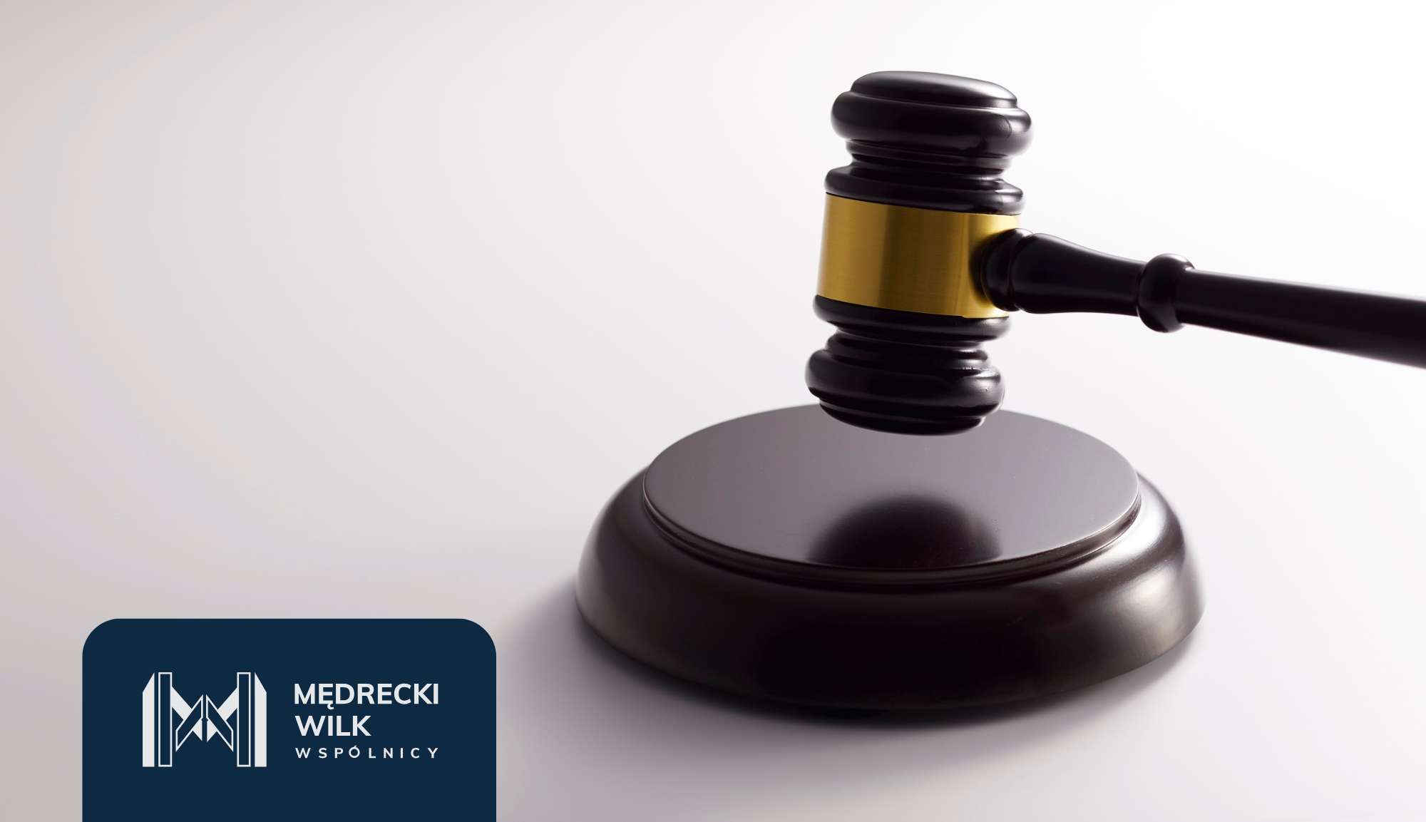 Close-up of a judicial gavel striking a sound block on a light background, with a dark blue law firm logo in the bottom-left corner.