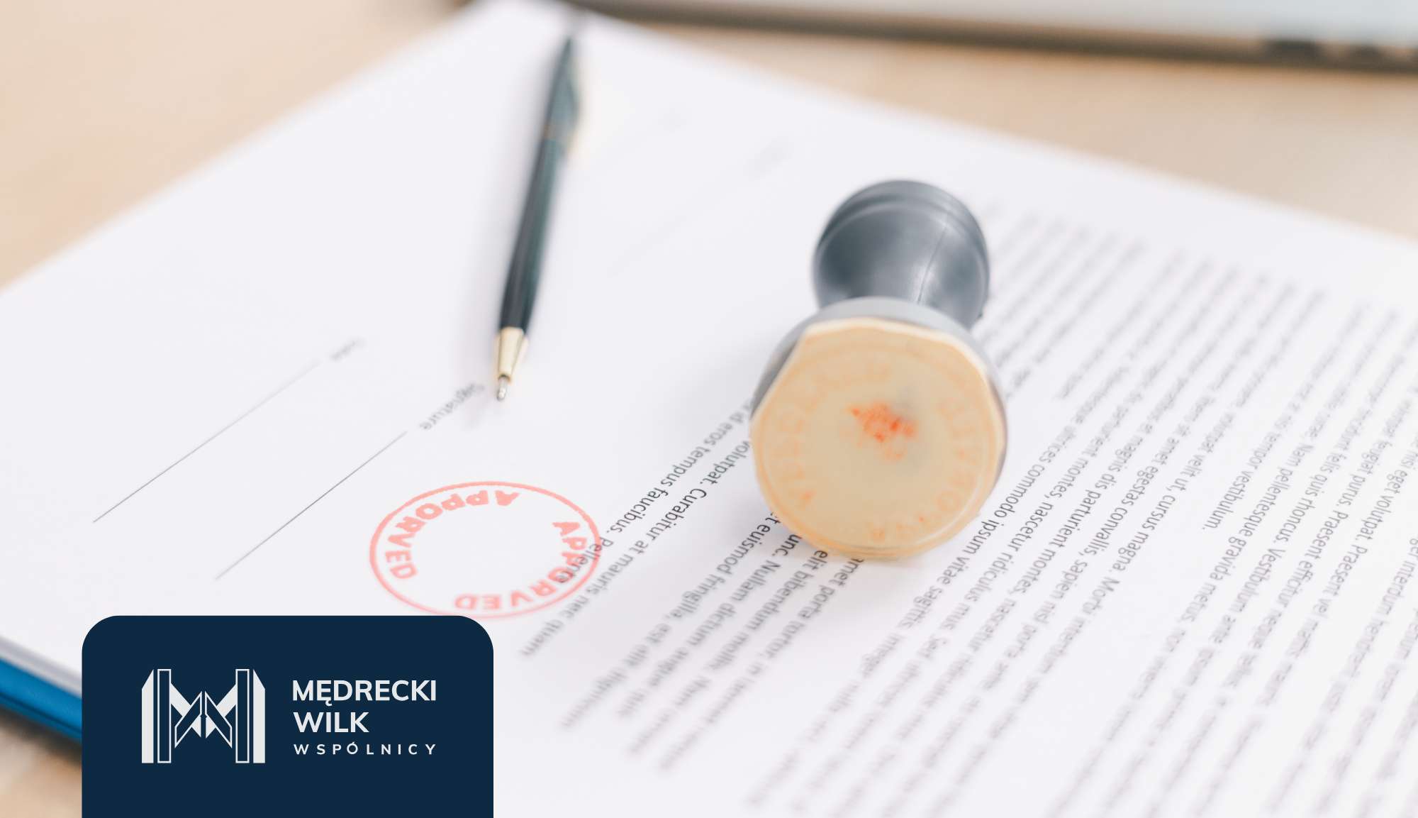 Close-up of a legal document with a red circular stamp and a black pen resting on the page; a dark blue branding banner with a logo sits in the bottom-left corner.