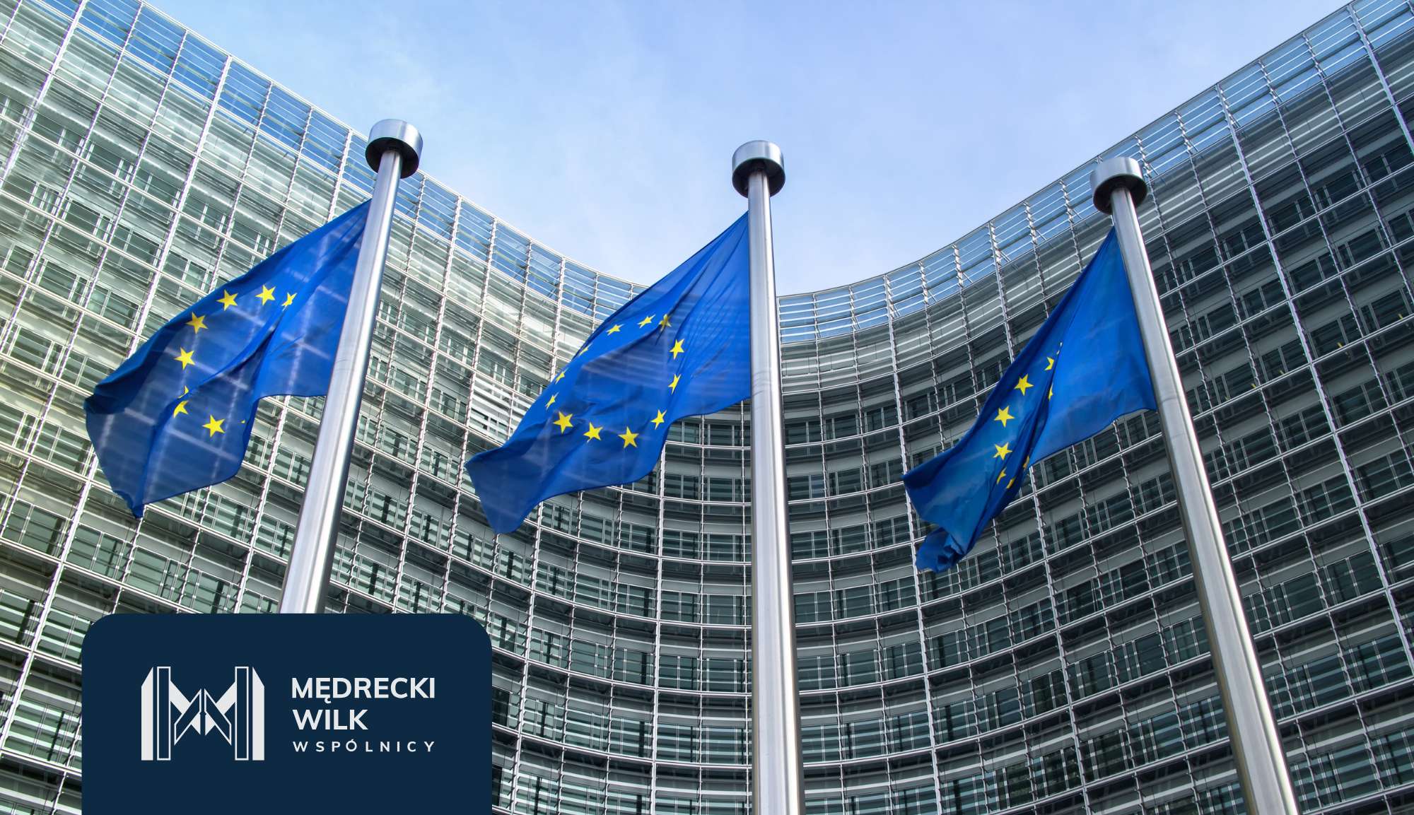 EU flags on tall poles in front of a curved glass office building; branding panel visible in foreground.