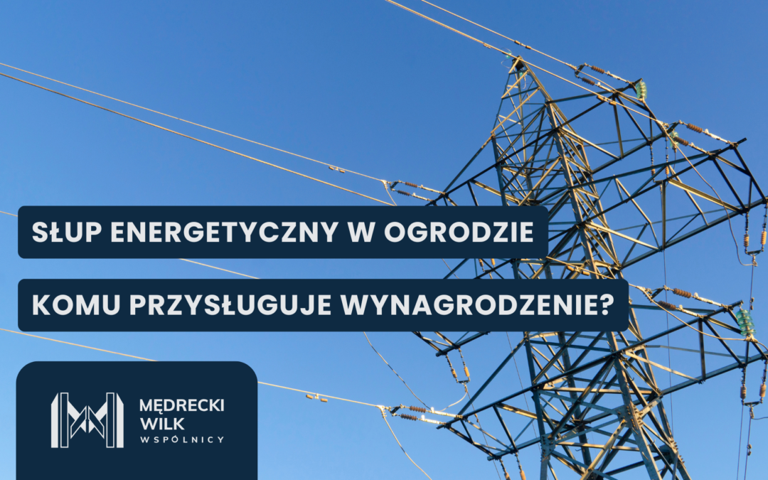 Informational banner on an electrical transmission tower with bold Polish headlines about an energy pole in the garden and who is entitled to compensation, set against a blue sky.