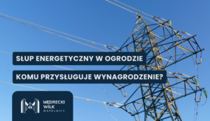 Informational banner on an electrical transmission tower with bold Polish headlines about an energy pole in the garden and who is entitled to compensation, set against a blue sky.