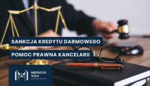 Polish legal-aid banner with scales of justice, gavel, and glasses on a desk, overlaid with text about free credit sanctions and legal help for the firm.